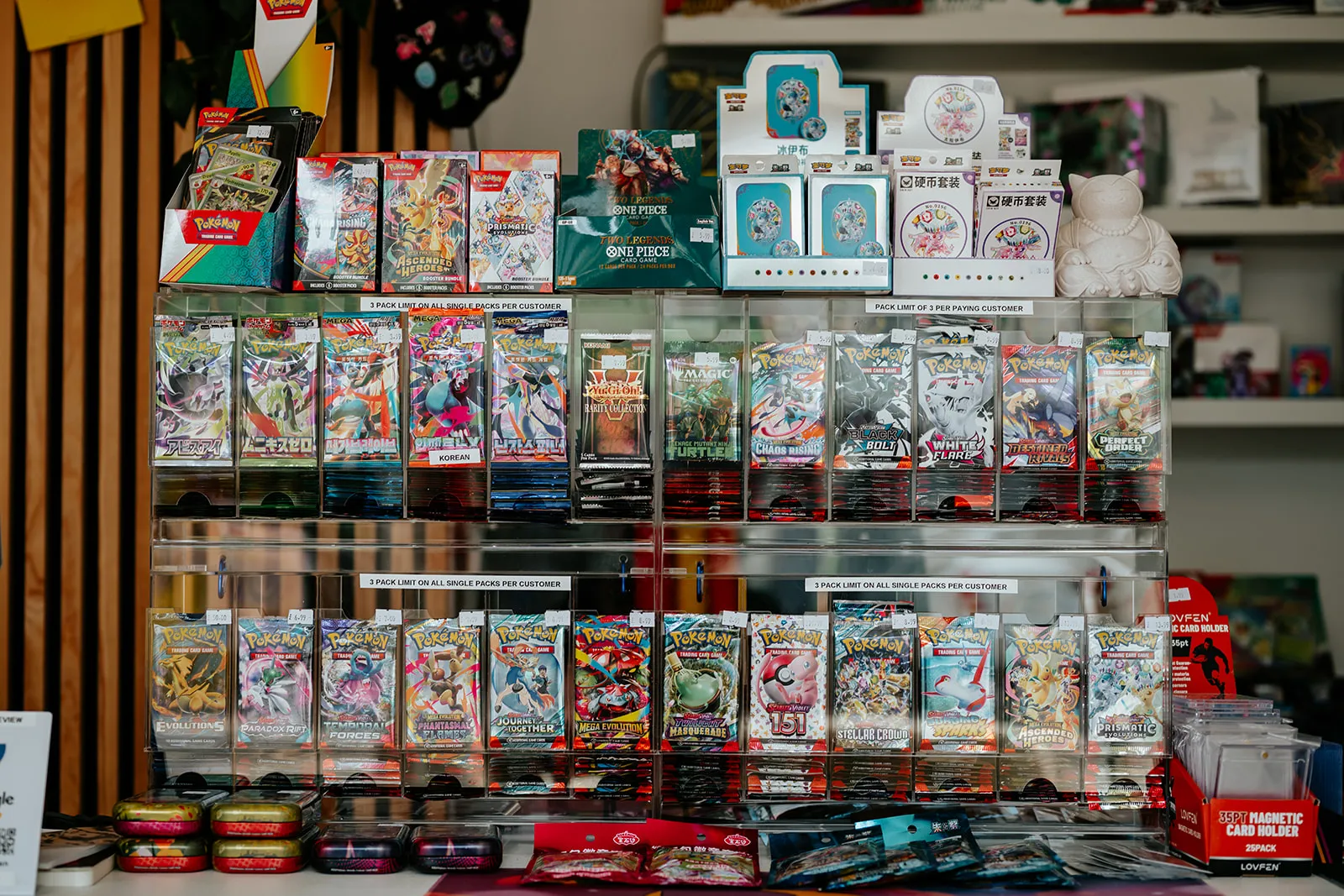 Sealed booster packs and boxes on display at Card Guys
