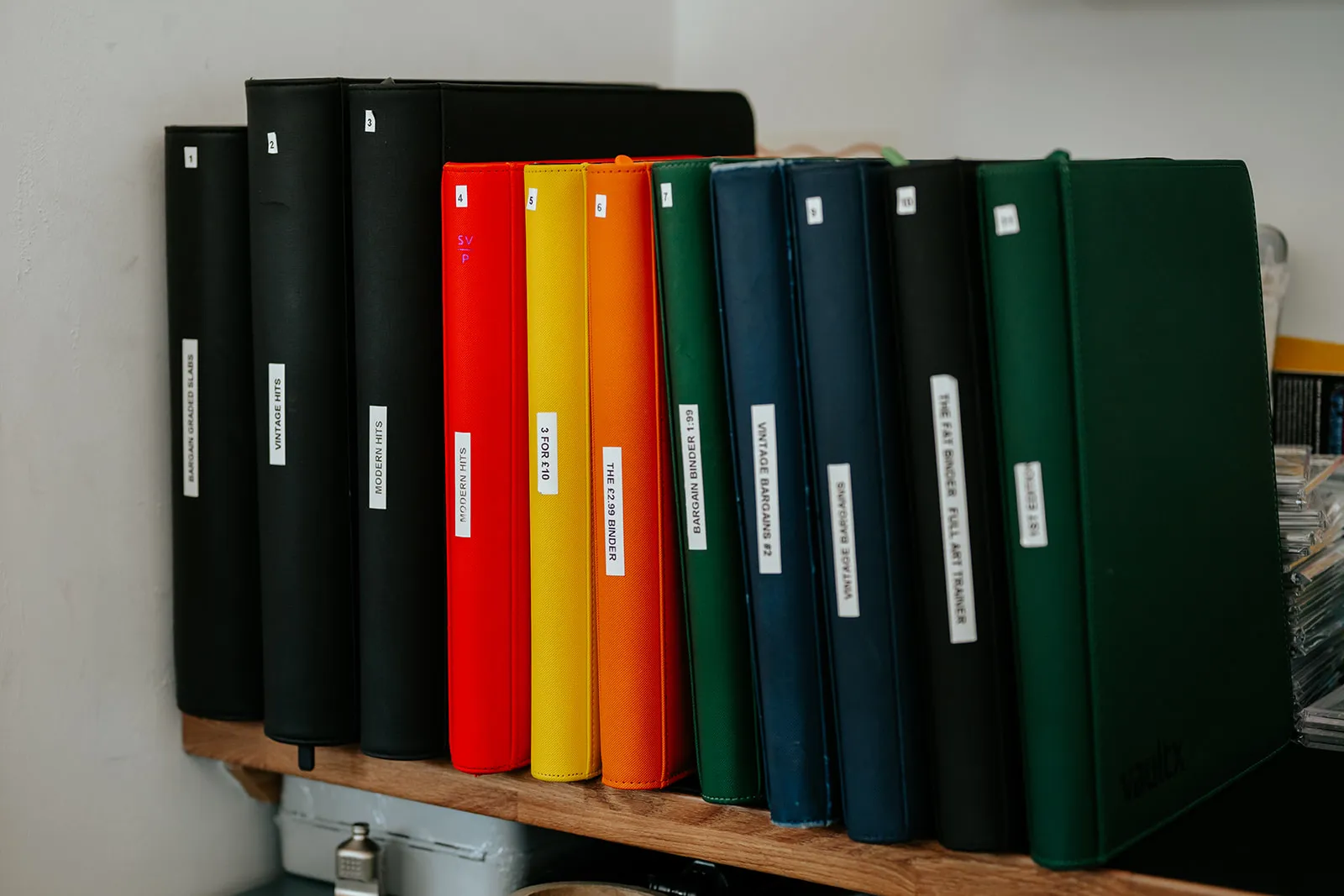 A shelf of binders full of single cards at Card Guys