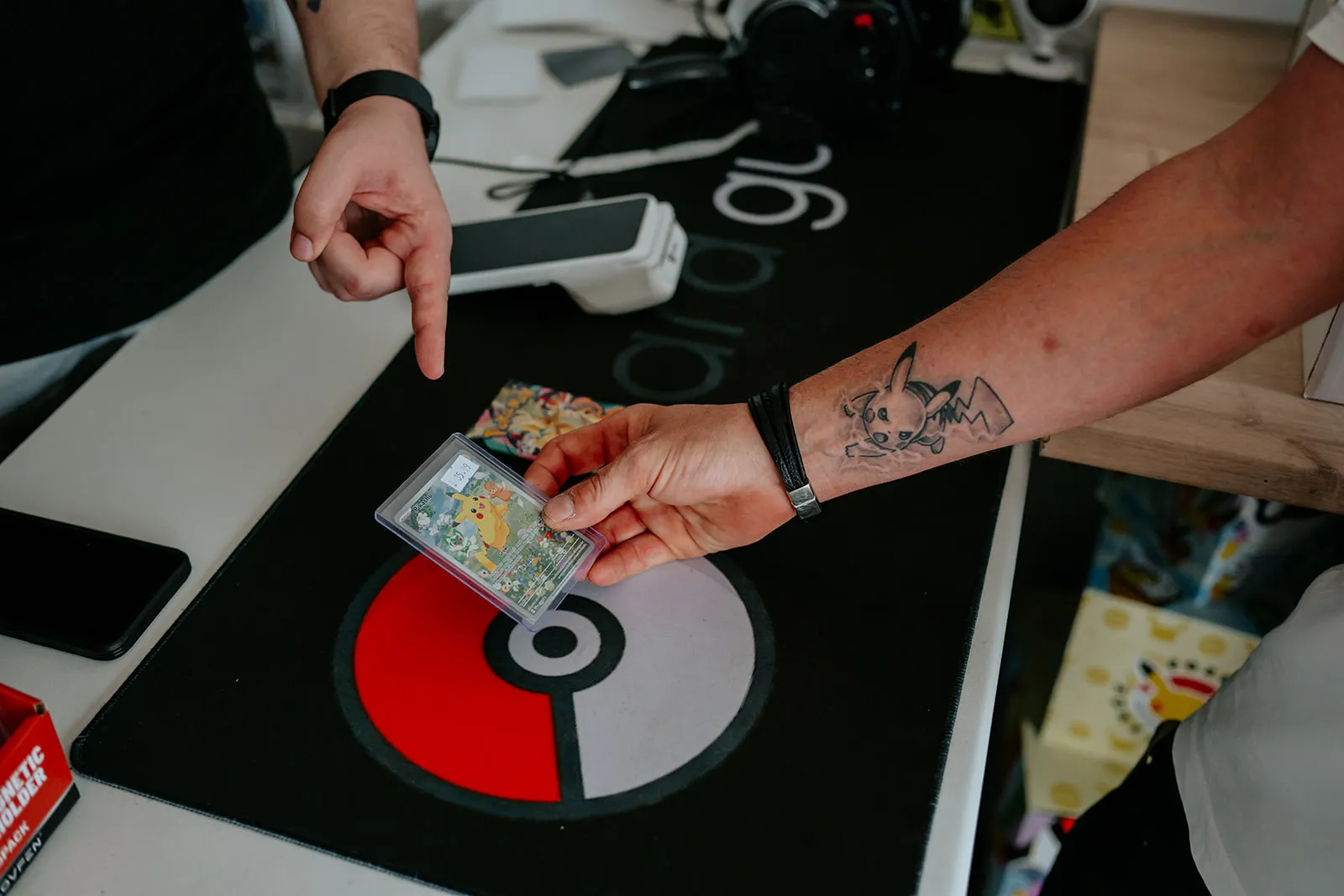 A graded Pokémon card on the counter at Card Guys
